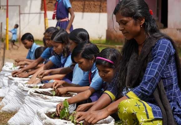Children making grow bags under our biodiversity curriculum